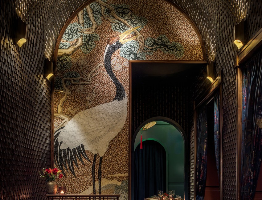 a mosaic wall with a crane painting on it