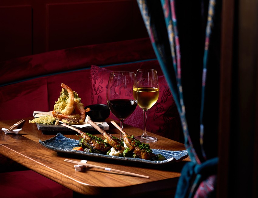 a plate of food on a table with wine glasses