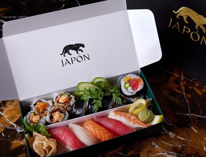 a box of sushi with a black logo