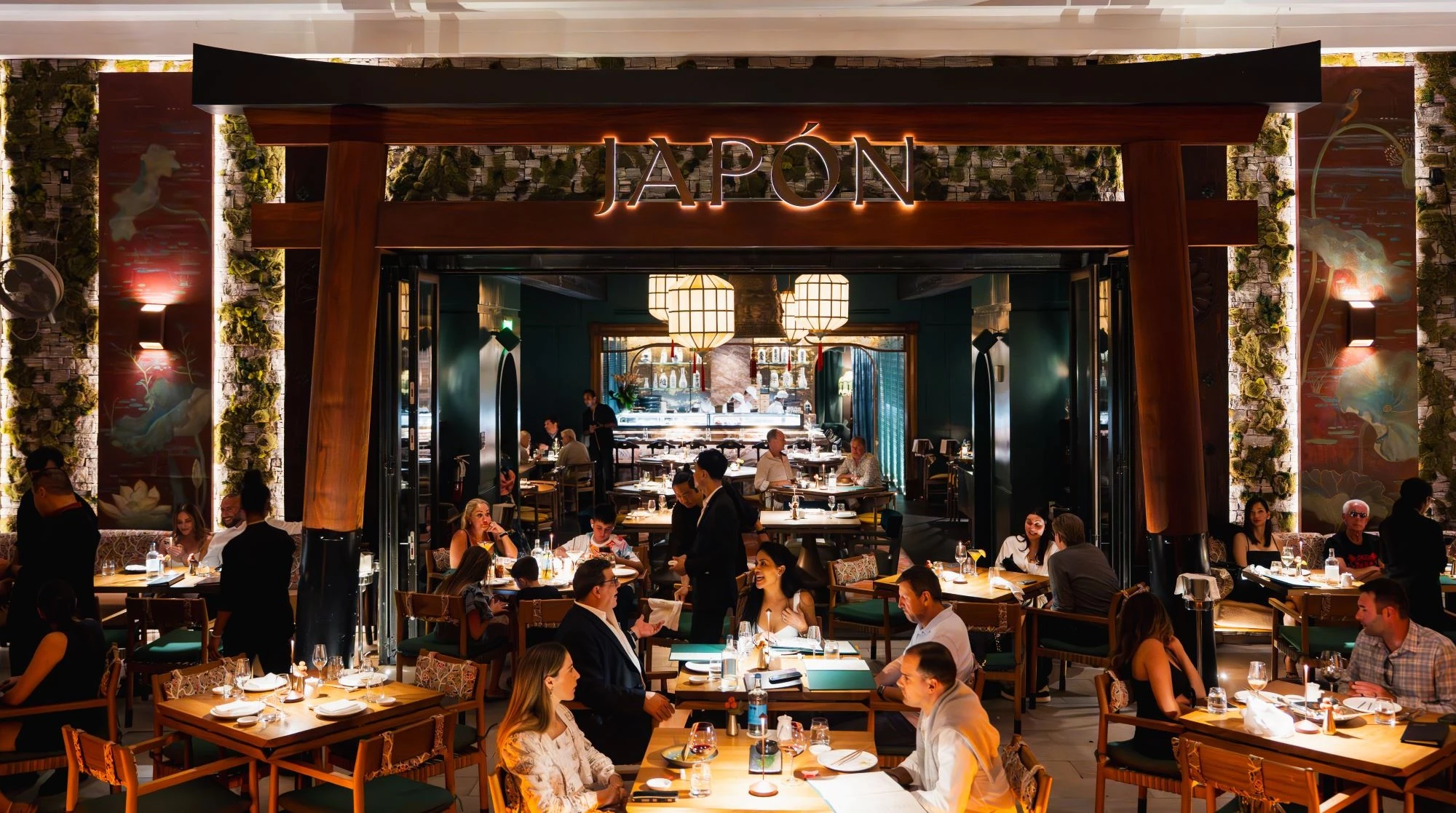 a group of people sitting at tables in a restaurant