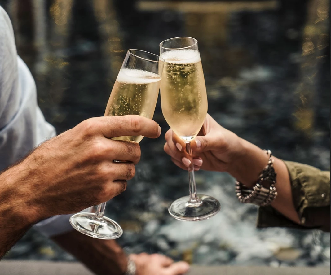 two people toasting with glasses of champagne