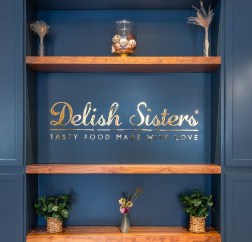 a blue wall with shelves and plants