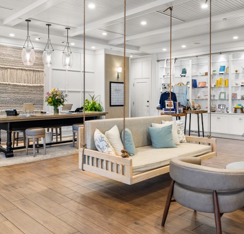 a room with a swing and chairs