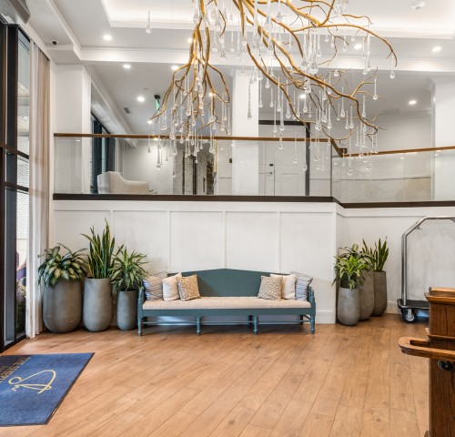 a room with a chandelier and a couch