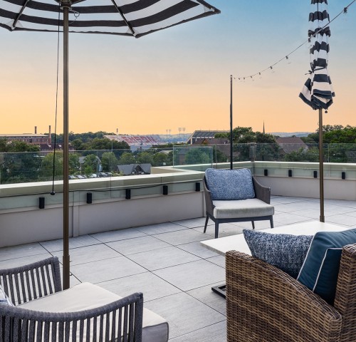 a patio with chairs and umbrellas