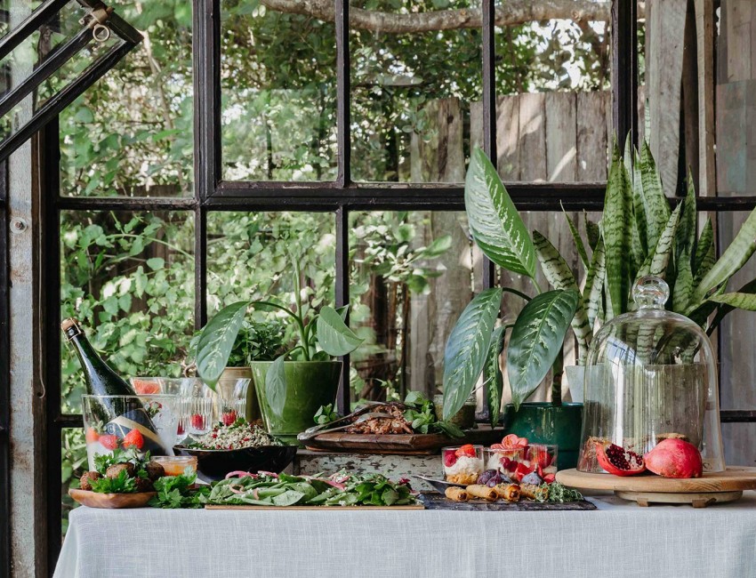 assortment of bright foods on table with greenery