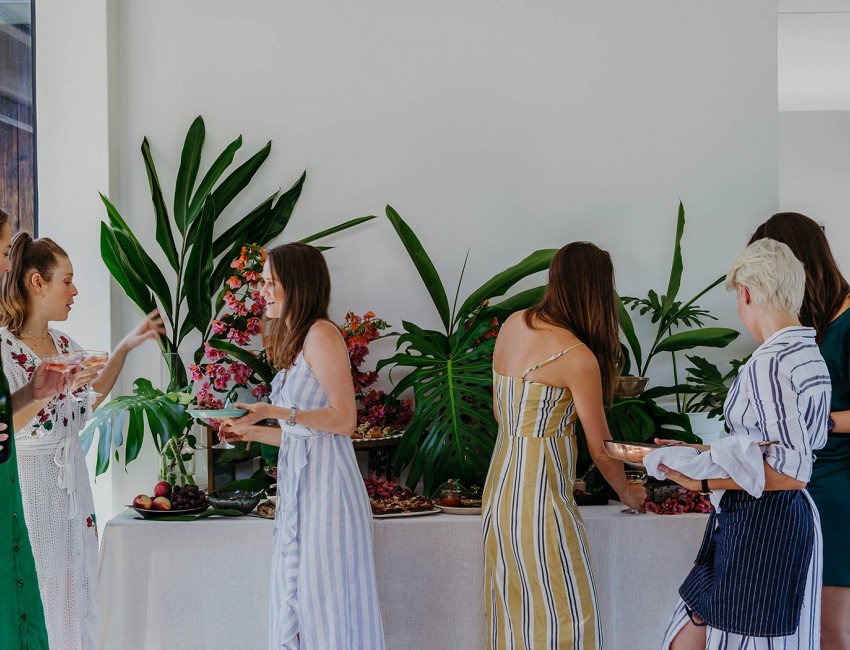people standing enjoying food
