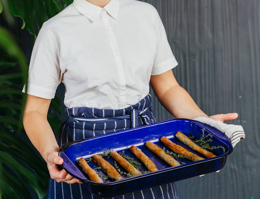 woman smiling holding tray of food