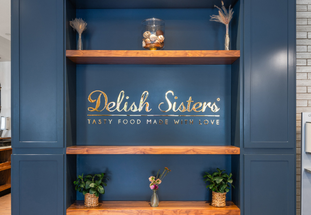 a blue wall with shelves and plants
