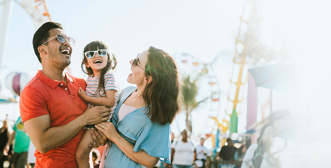 a man holding a woman and a child