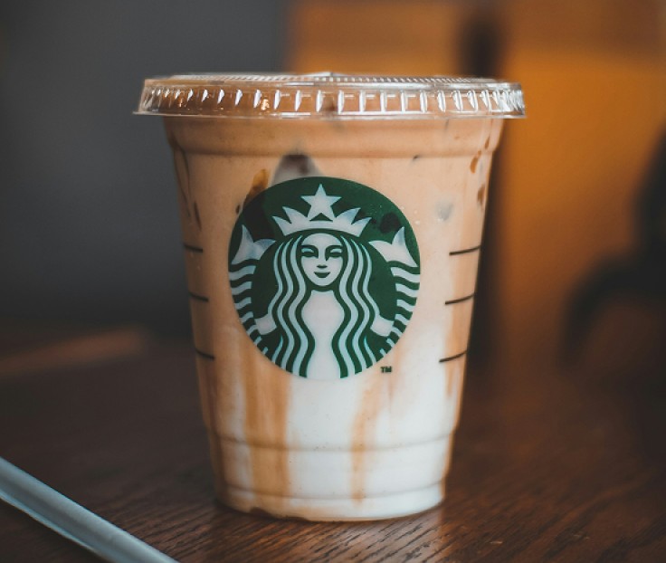 a cup of coffee with a lid and a straw