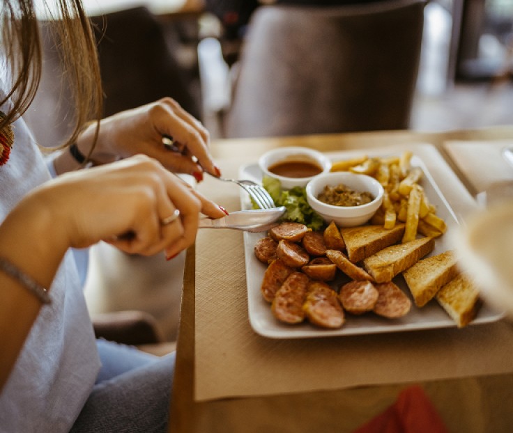 a person eating food on a plate
