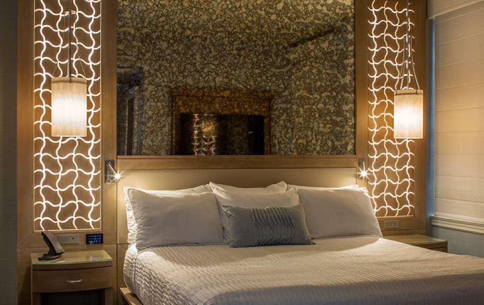 a bed with a mirror above it