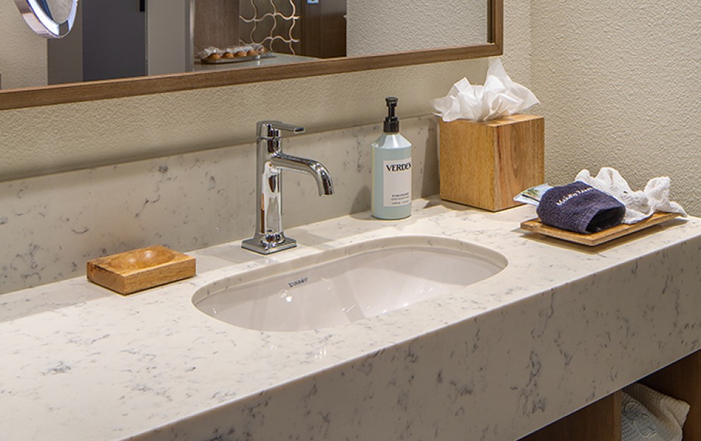 a bathroom sink with a mirror and a towel