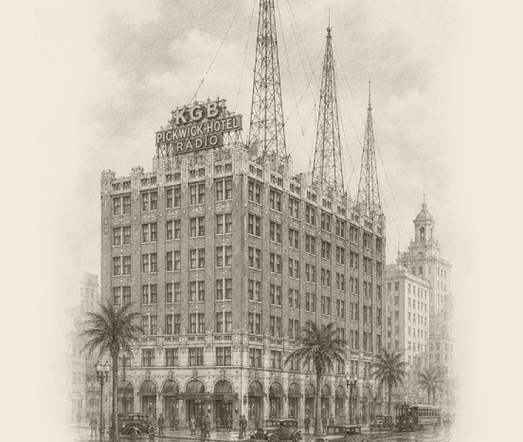 a building with palm trees and cars