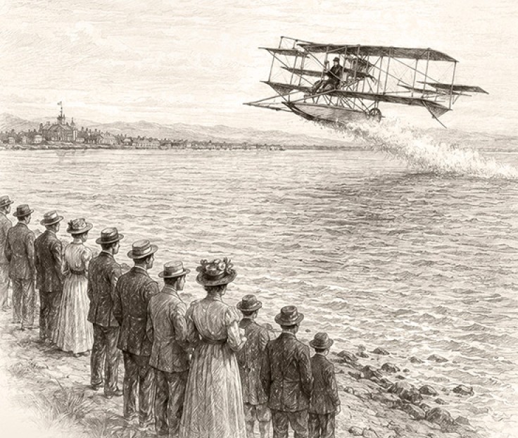 a group of people watching a biplane flying over water