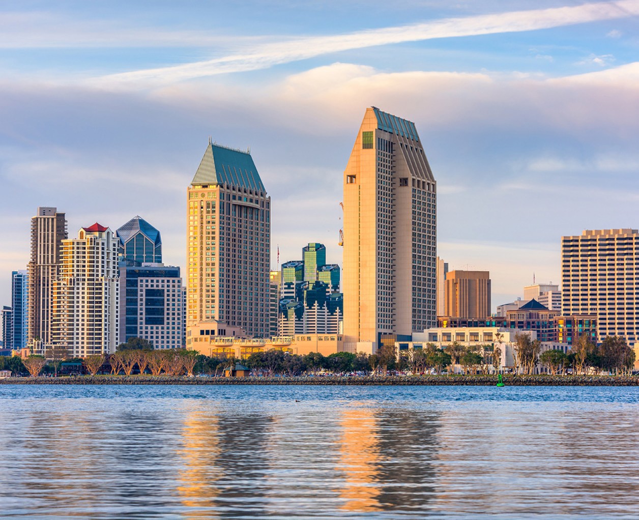 a city skyline with water in the background