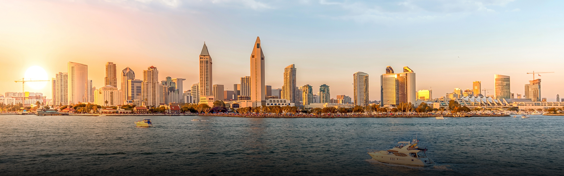 a city skyline with many tall buildings and a body of water