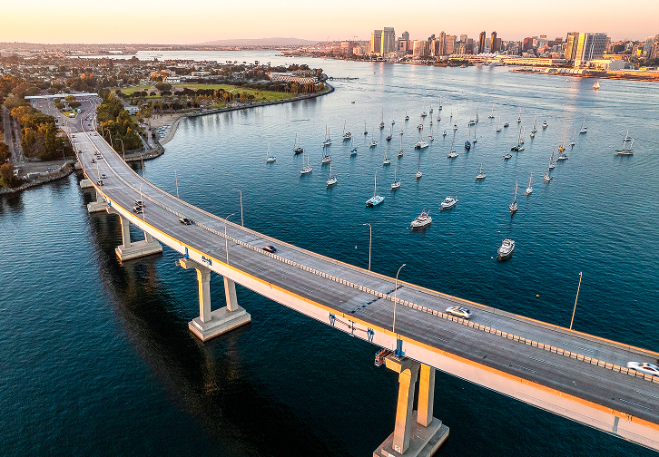 a bridge over water with many boats