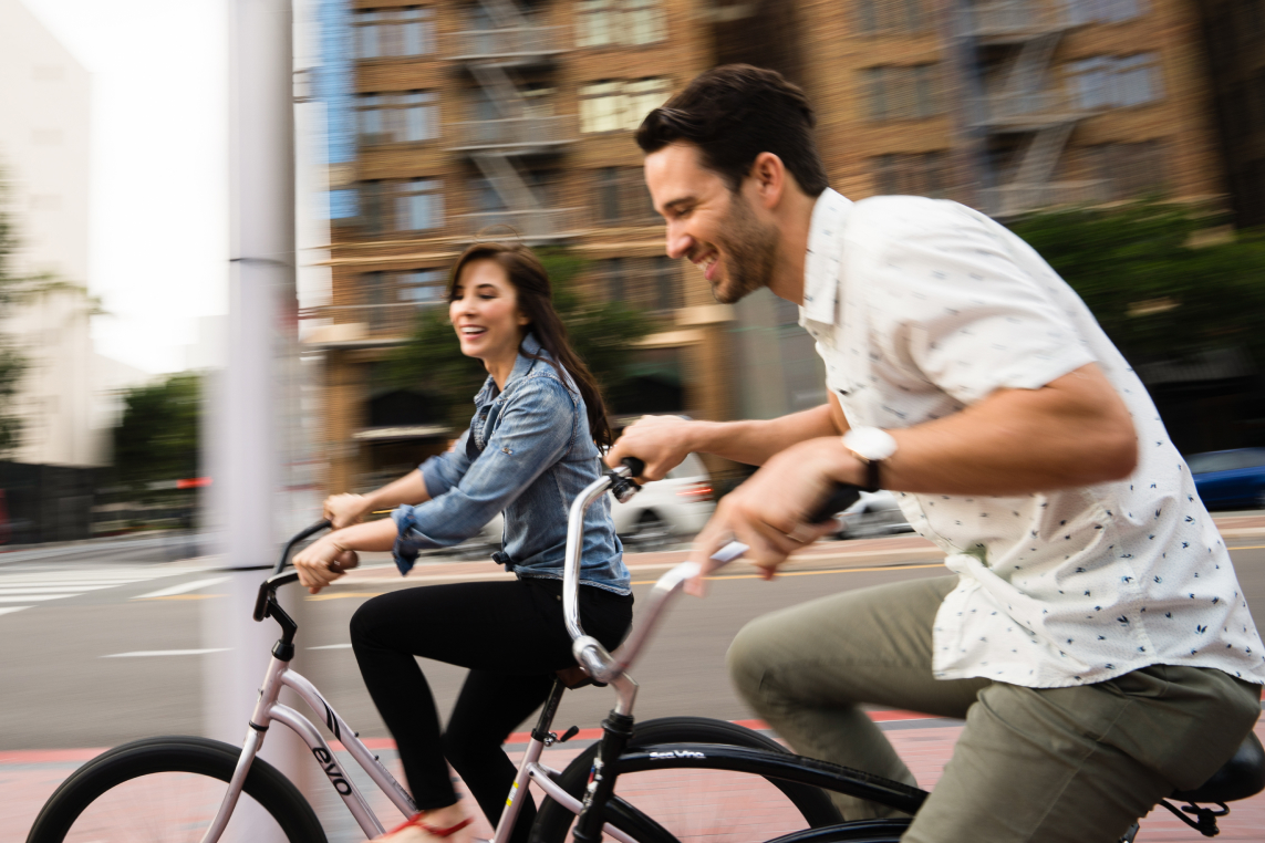 a man and woman riding bicycles