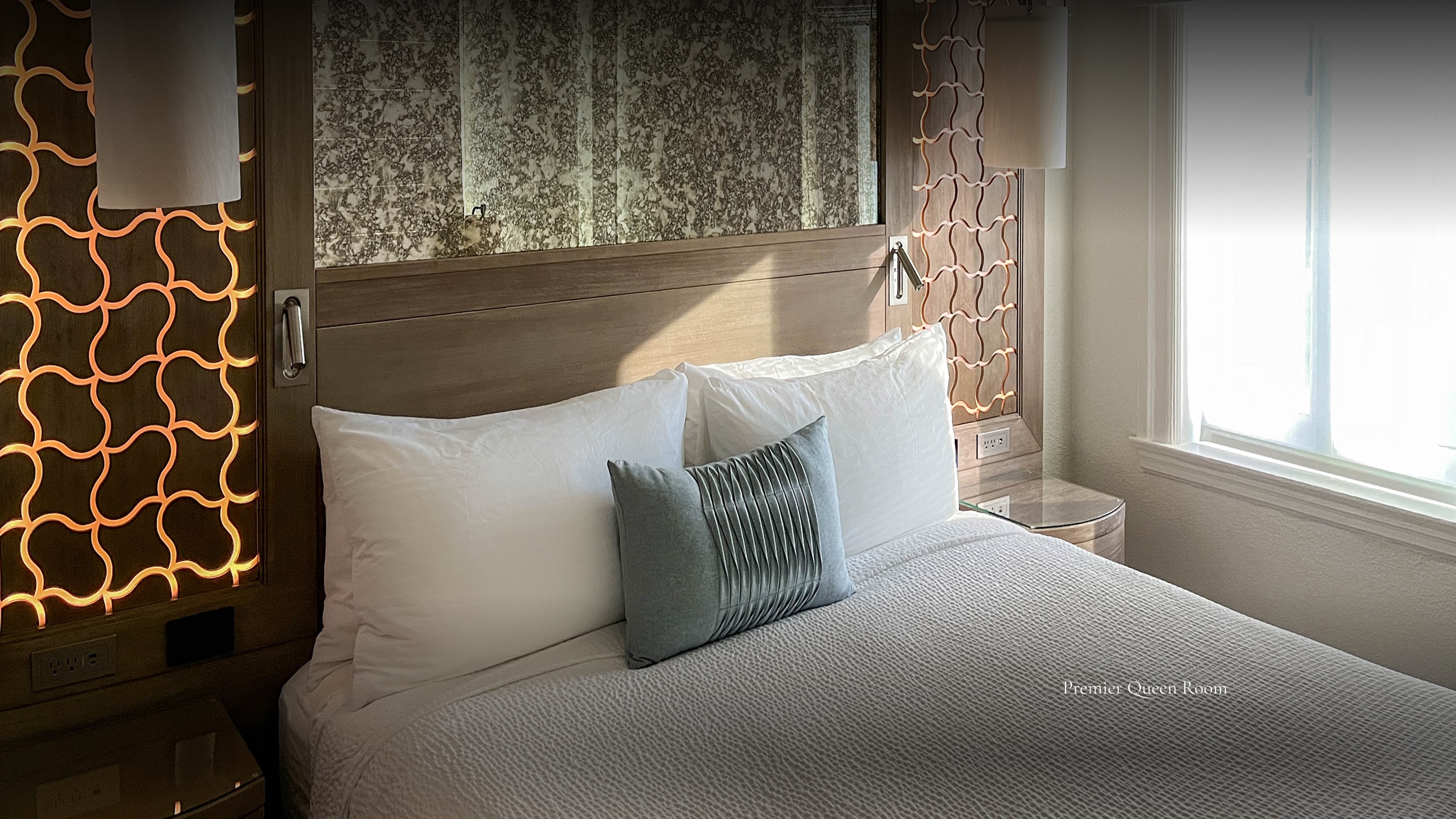 a bed with pillows and a lamp