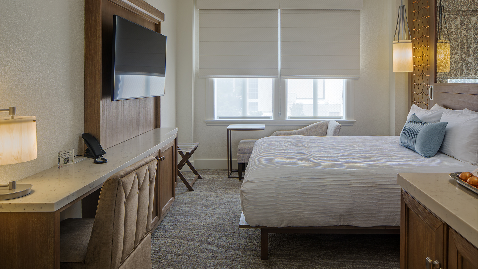 a bedroom with a tv and a bed