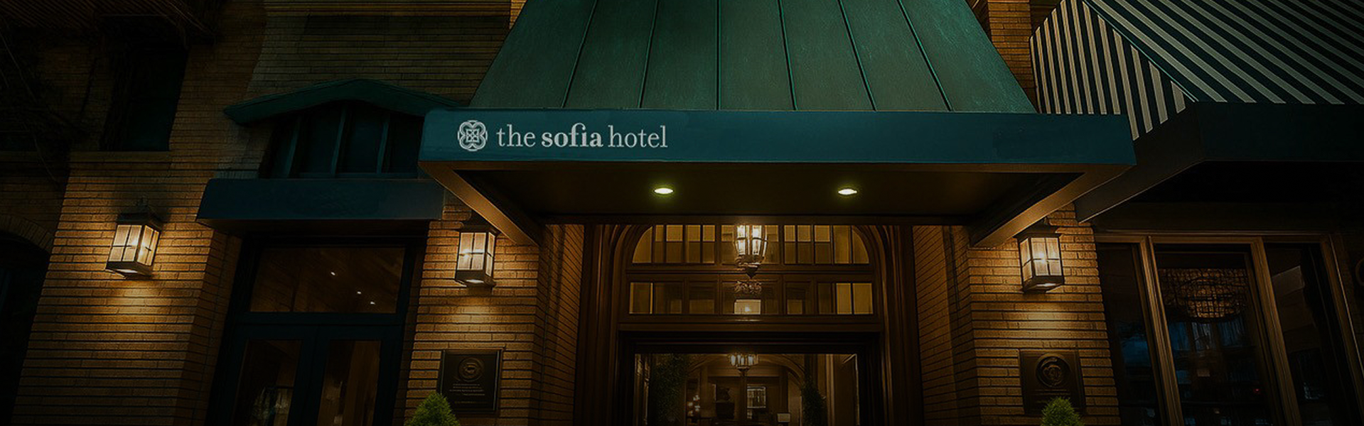 a hotel entrance with a green awning