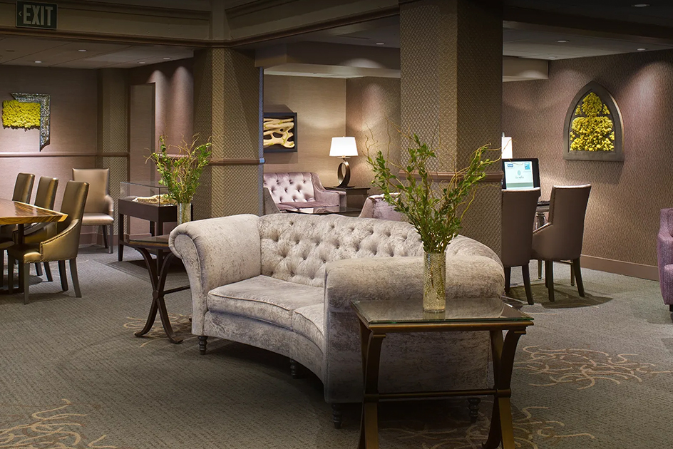 a room with a couch and a vase of flowers