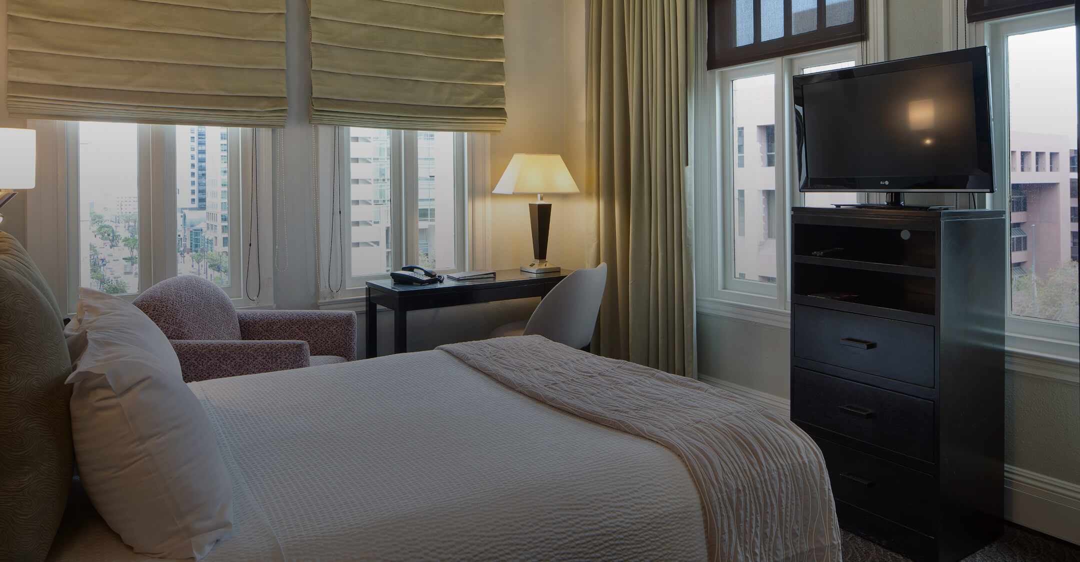 a room with a bed and a tv