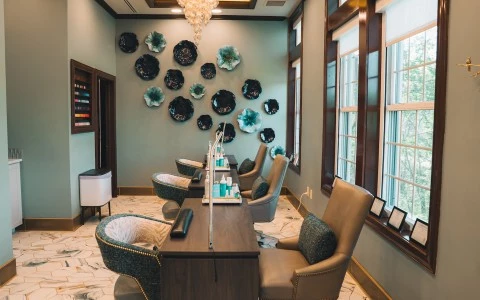 a room with chairs and a chandelier