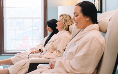 a group of women sitting in chairs