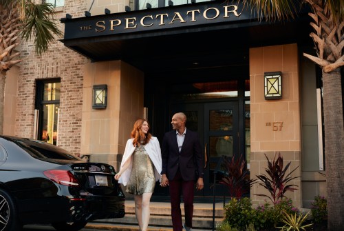 a man and woman walking in front of a building