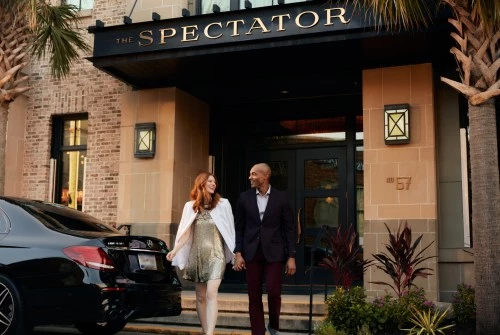 a man and woman walking in front of a building