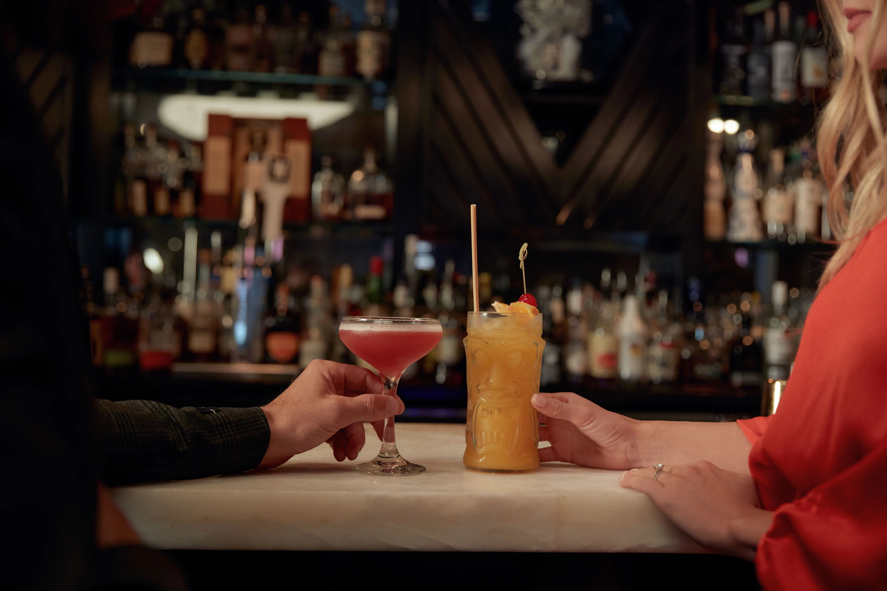 a couple of hands holding drinks