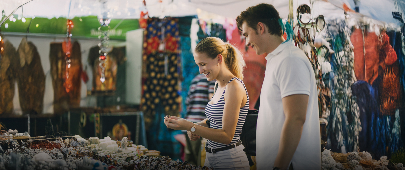 a man and woman looking at objects