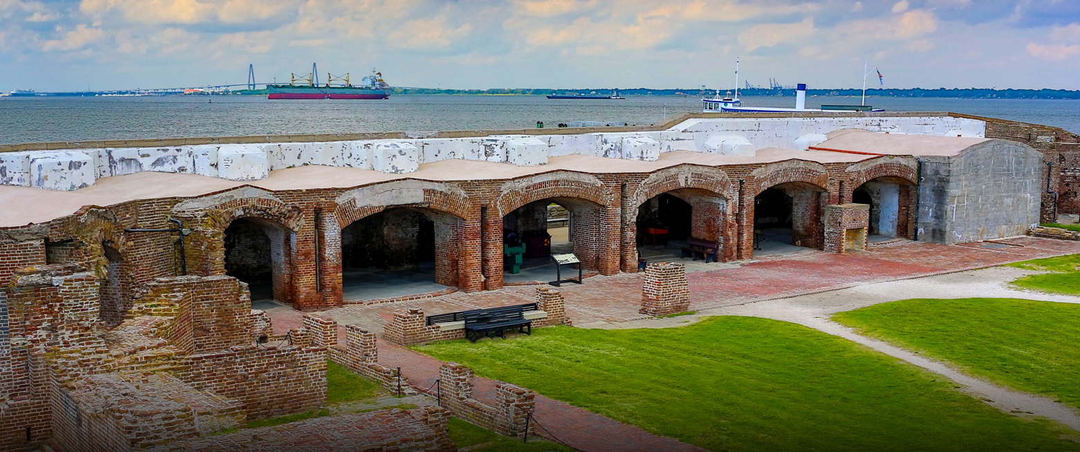 a brick building with a large body of water in the background