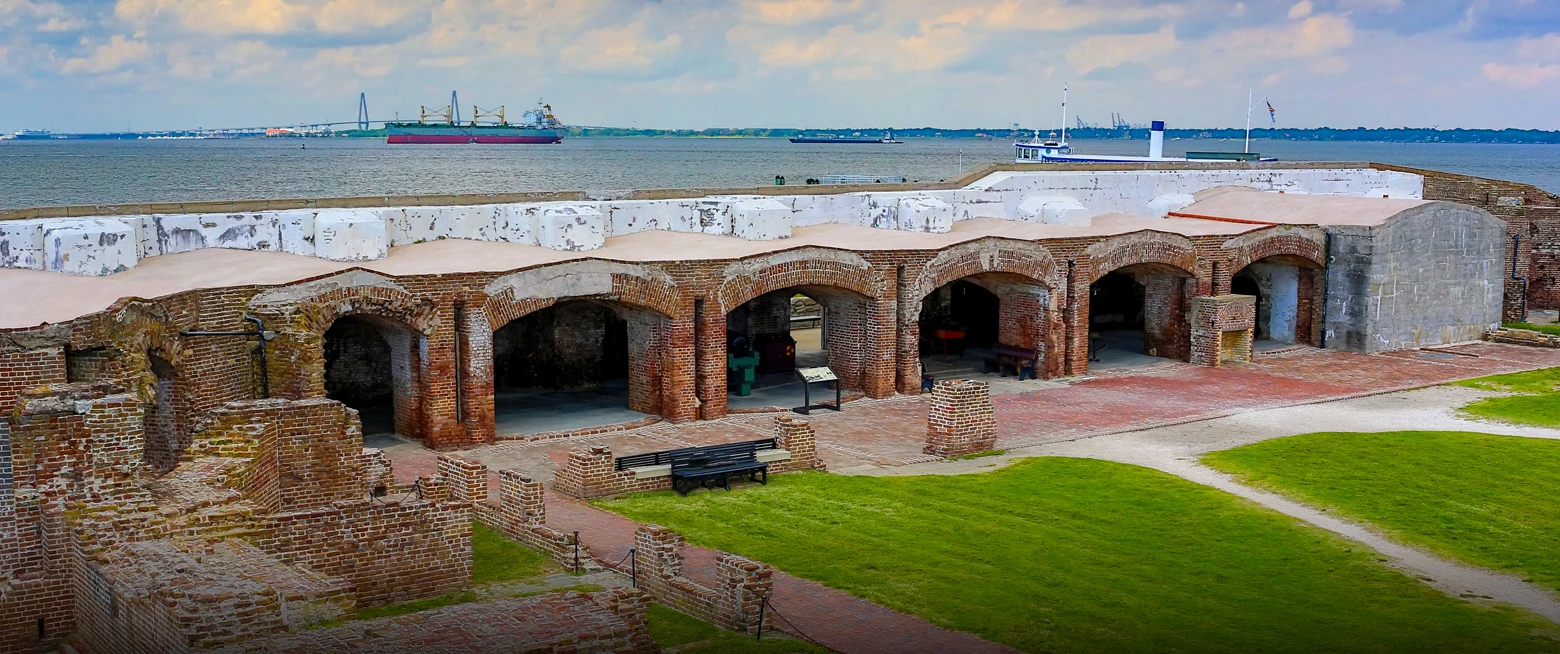 a brick building with a large body of water in the background
