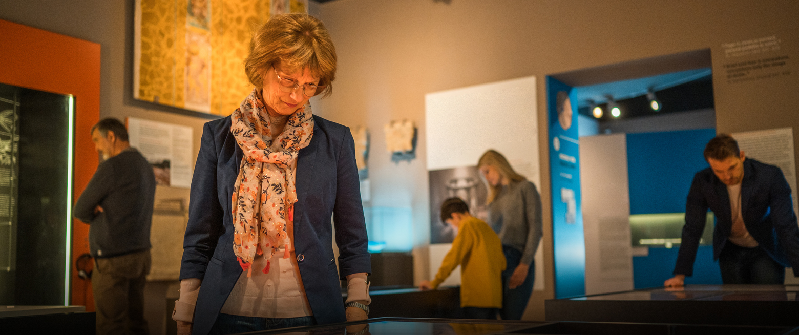 a woman looking down at a display