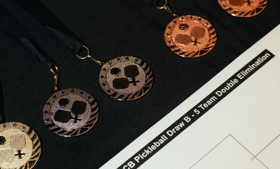 a group of medals on a black surface