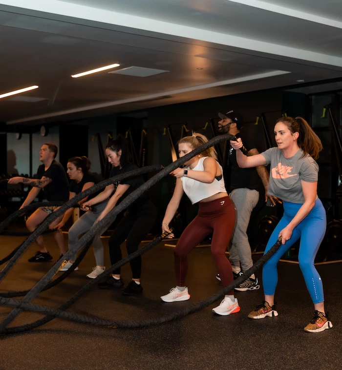 a group of people working out with ropes