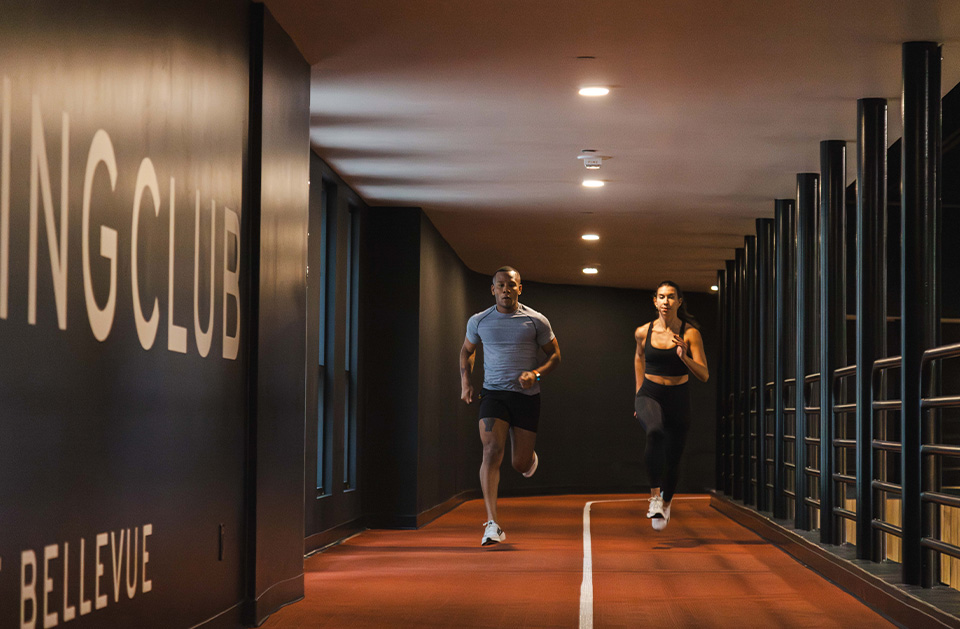 a man and woman running in a hallway