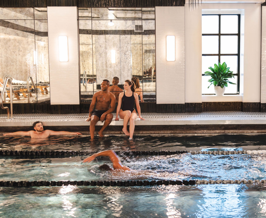 a group of people sitting in a pool