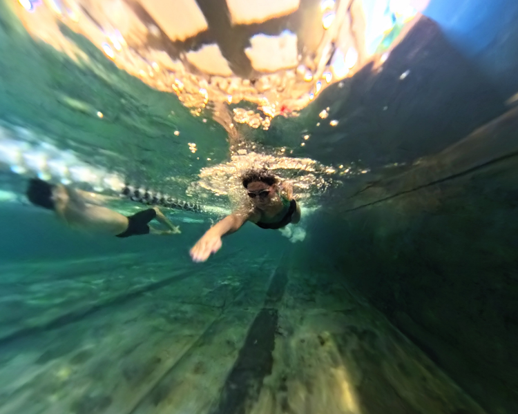 a person swimming underwater with glasses