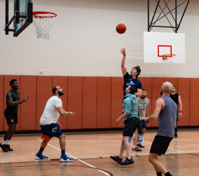 a group of people playing basketball