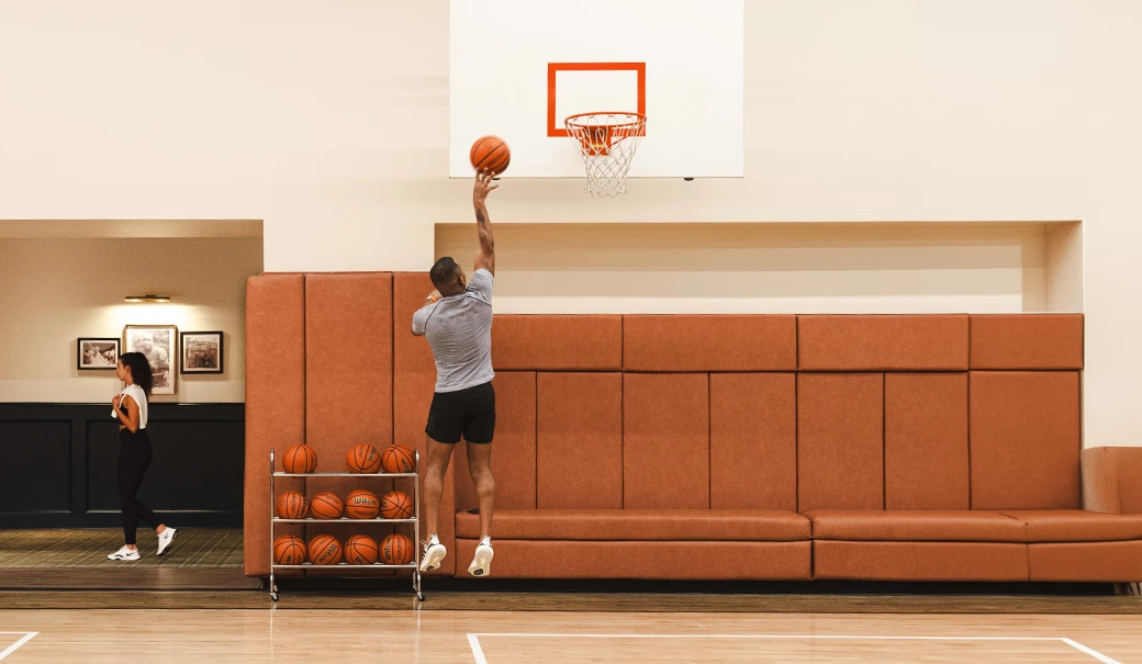 a man jumping to shoot a basketball