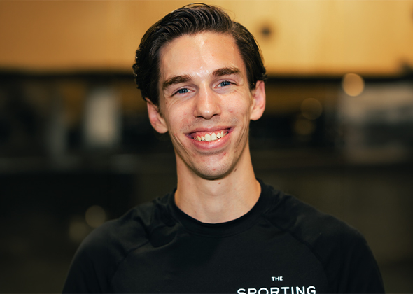a man smiling at the camera