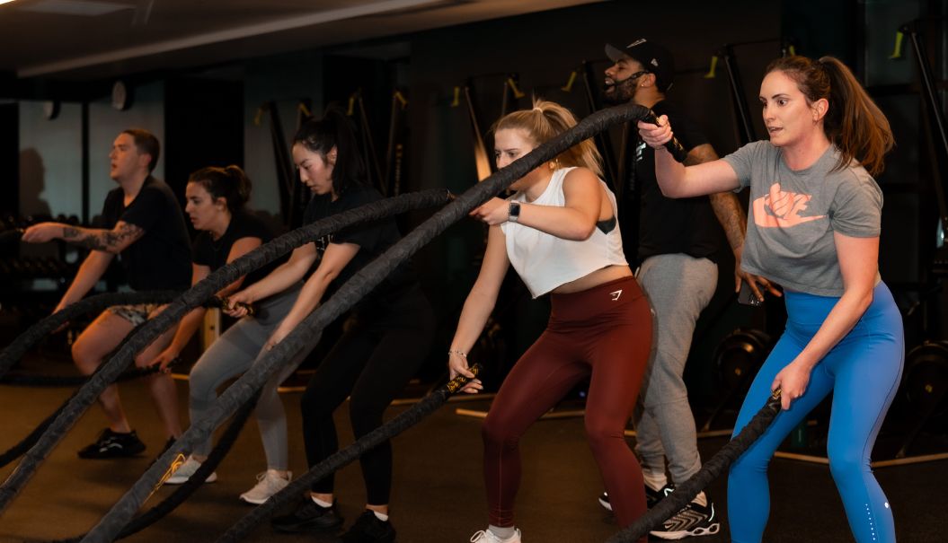 a group of people working out with ropes