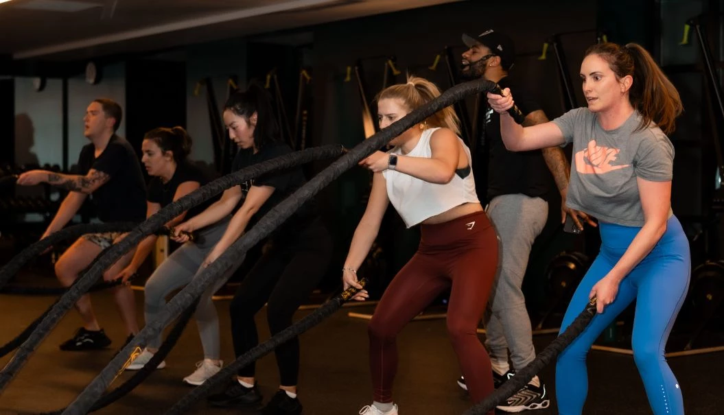 a group of people working out with ropes