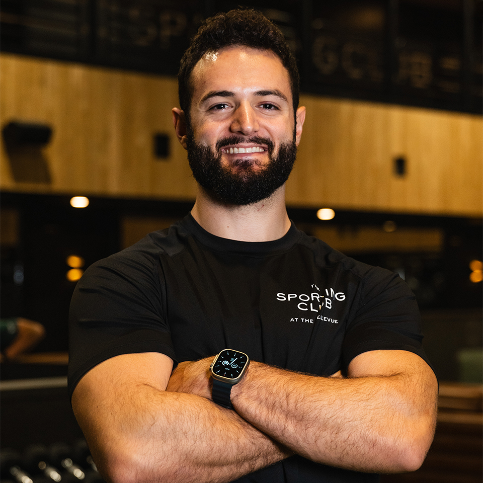 a man with beard and black shirt with arms crossed