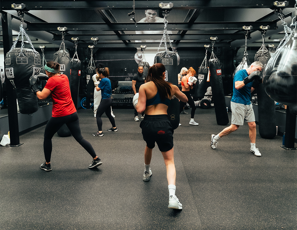 a group of people in a gym boxing